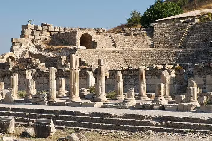 Ephesus ruins with ancient columns and stone structures, highlighting historical exploration on a Kusadasi tour.