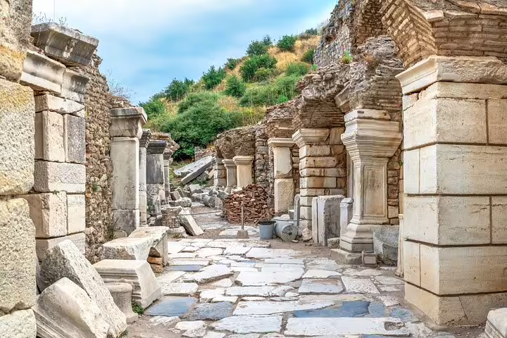 Ancient Ephesus ruins with stone columns and pathways on 2-day tour from Istanbul.