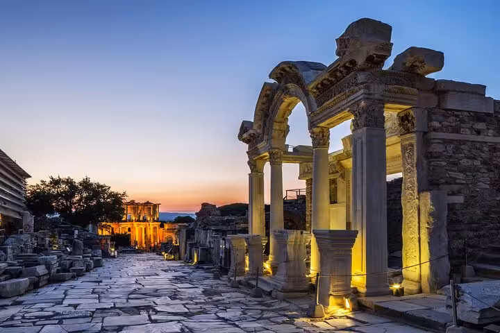 Sunset view of illuminated Ephesus ruins and arches on a private full-day guided Ephesus tour from Istanbul