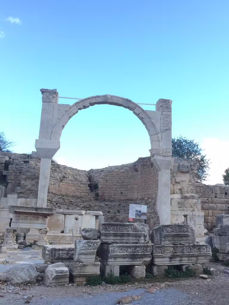 Ancient stone arch and carved marble ruins in Ephesus on an all-inclusive private tour with lunch