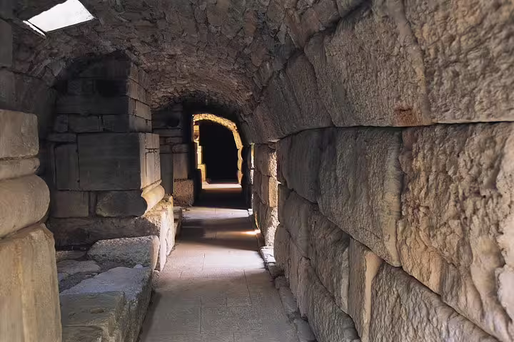Stone-arched tunnel passage in ancient Ephesus, guided walk on private Ephesus tour from Izmir Cruise Port