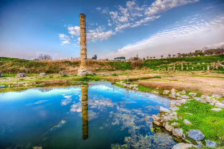 Majestic ruins of the Temple of Artemis reflecting in a tranquil pool on the Ephesus day tour from Istanbul.