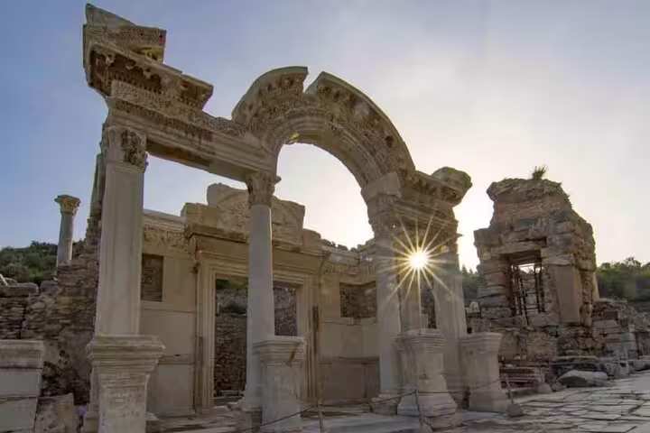 Sunlight streaming through the Temple of Hadrian ruins in Ephesus, a highlight of the private tour from Izmir Port.