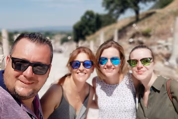 Small group Ephesus tour travelers smiling at ancient site, visiting House of Virgin Mary with lunch