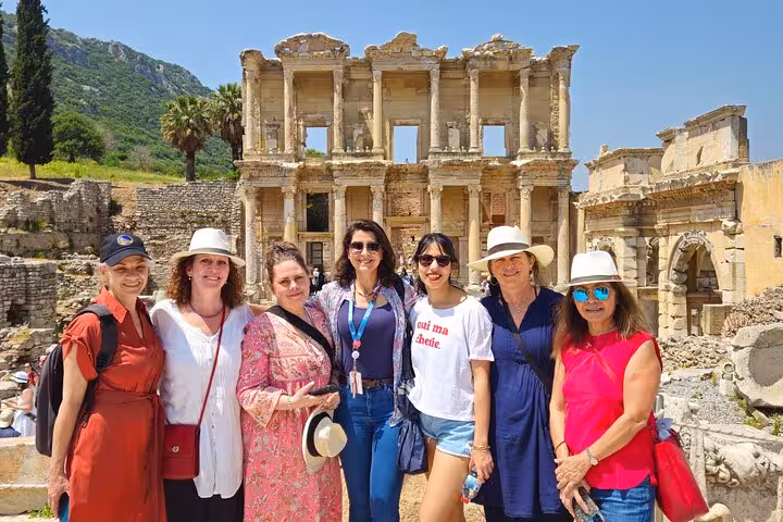 Guided Ephesus tour from Izmir hotels with travelers posing at the Library of Celsus ruins in Selcuk, Turkey