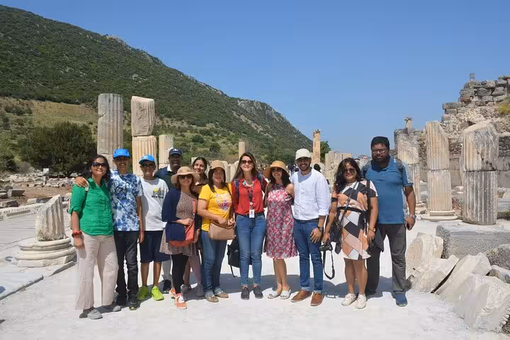 Travel group posing among ancient columns on Ephesus tour from Kusadasi, small-group guided day trip