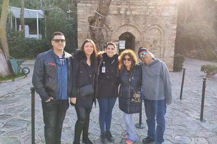 Tour group stands outside the House of Virgin Mary near Ephesus, included in Kusadasi shore excursion tours