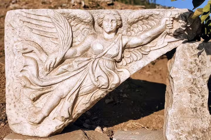 Winged marble relief sculpture at Ephesus ruins visited on a full-day max 10 pax tour from Izmir