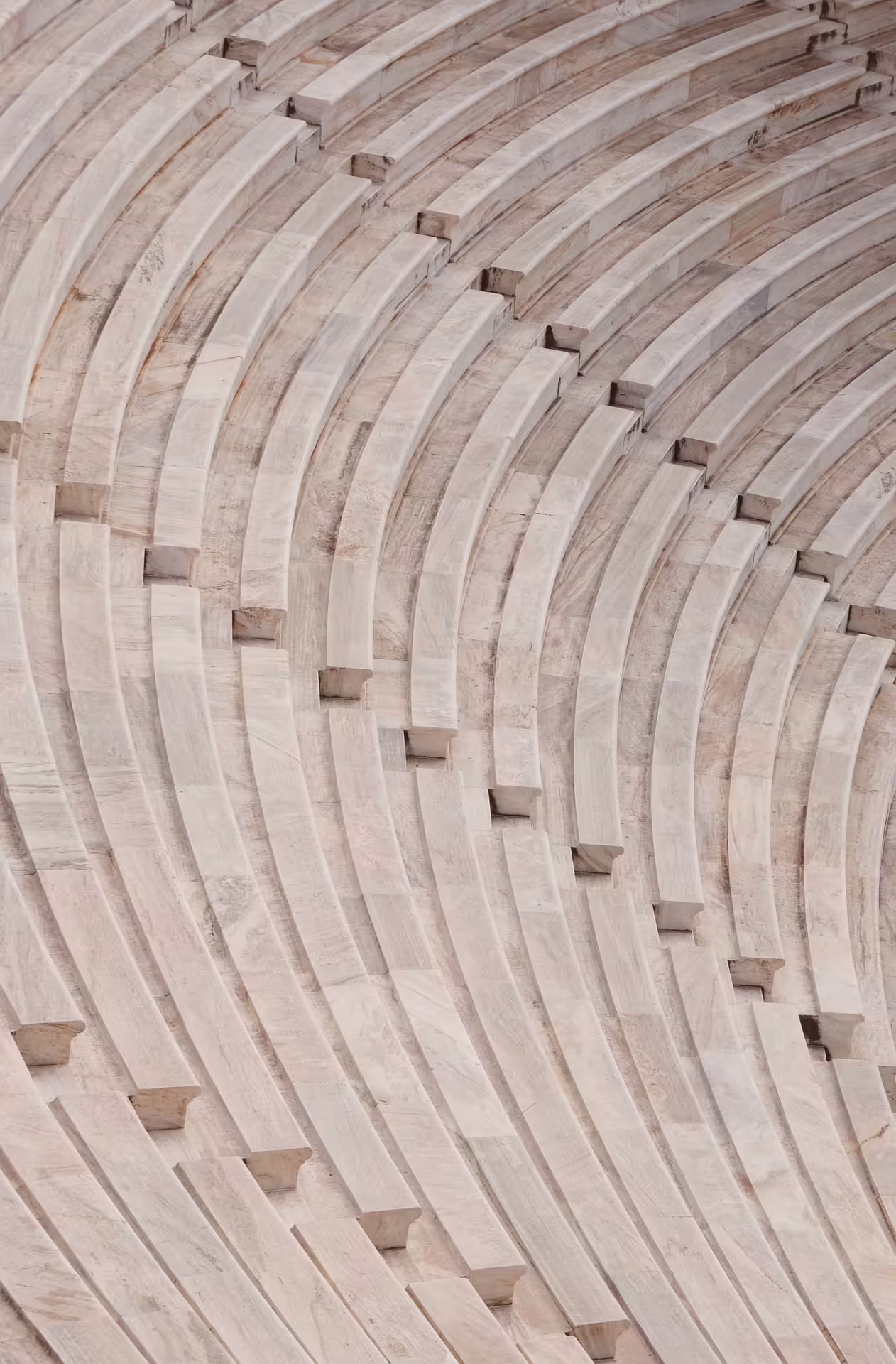 Curved marble seating at Epidaurus ancient theater, highlight of private tour from Athens to Corinth and canal