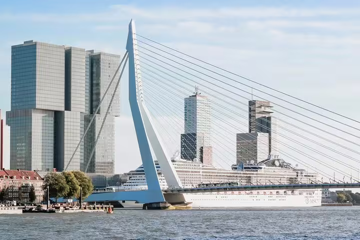 Erasmus Bridge with modern Rotterdam skyline and cruise ship on the Nieuwe Maas river