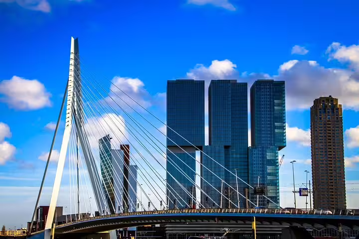 Erasmus Bridge and Rotterdam high-rises under blue sky, key stop on a private Amsterdam to Rotterdam tour with guide
