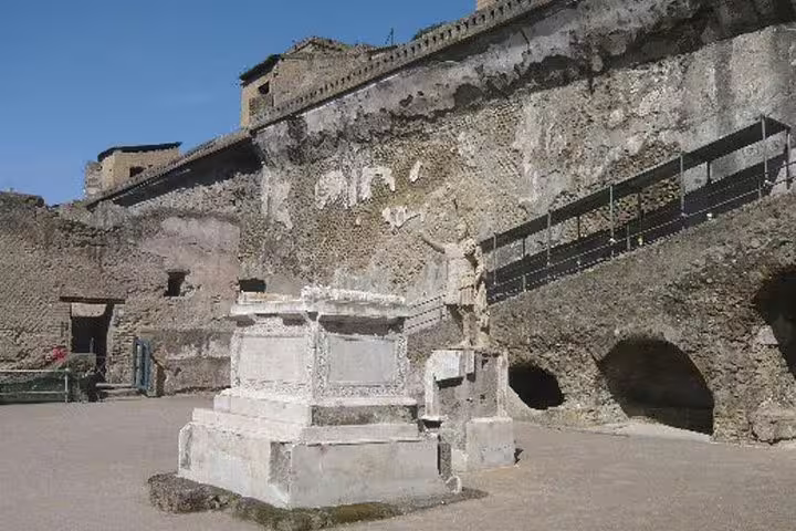 Ancient marble altar and stone arches in the archaeological ruins of Ercolano on a private full day tour from Naples