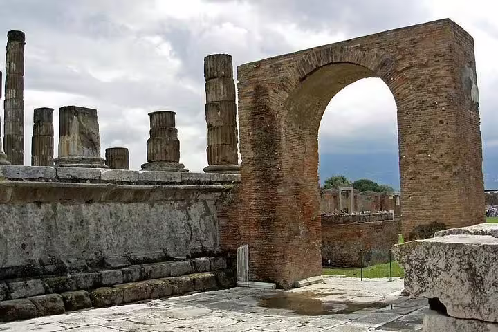 Brick archway and ruined columns of an ancient Roman forum near Mount Vesuvius on an Ercolano shore excursion
