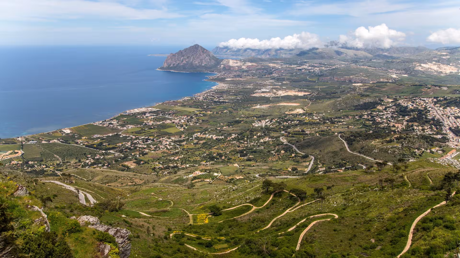 Panoramic view of Erice's lush landscape and coastline from above, ideal for scenic ebike tours from Trapani.