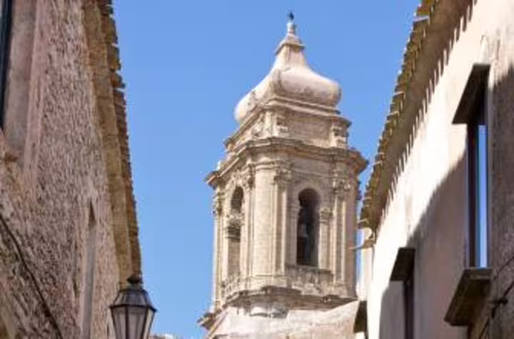 Erice old town street with historic church bell tower, a highlight on the Erice and Segesta tour from Palermo