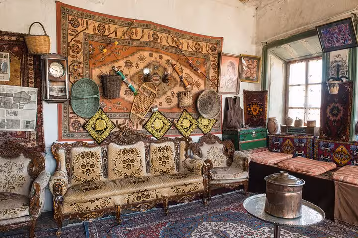 Traditional Erzurum house interior with antique rugs and seating on an all-inclusive private guided city tour