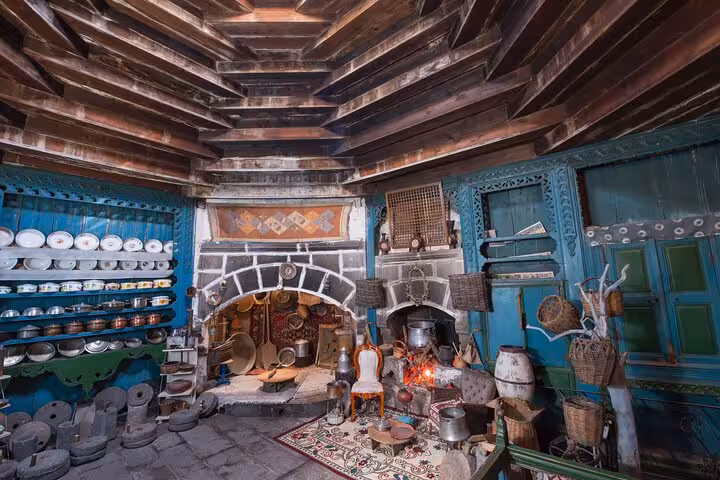 Traditional Erzurum kitchen museum with stone hearth, copper pots and shelves on an all-inclusive walking tour