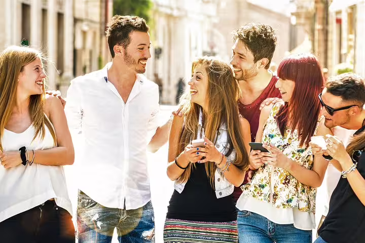 Friends using smartphones on an e-scavenger hunt in Den Bosch, exploring city streets at their own pace