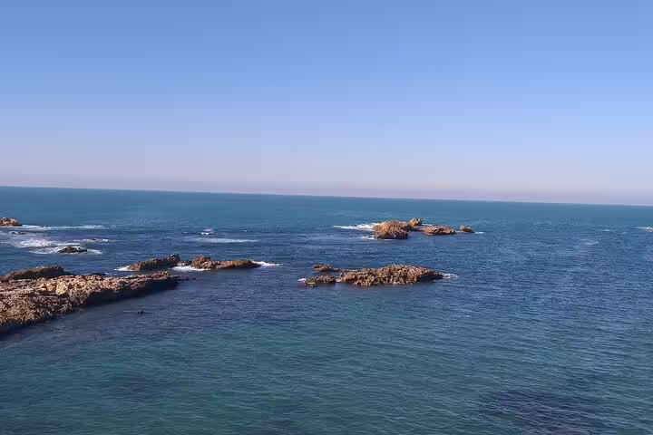 Rocky Atlantic coastline and blue waters in Essaouira, highlights of a private Marrakech to Essaouira day tour