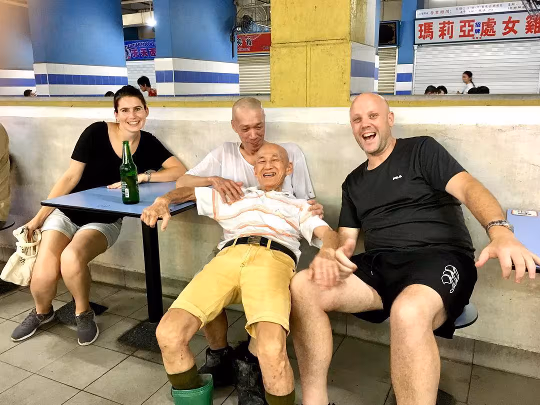 Tourists enjoying local company in an ethnic neighborhood during the UNESCO street food tour.