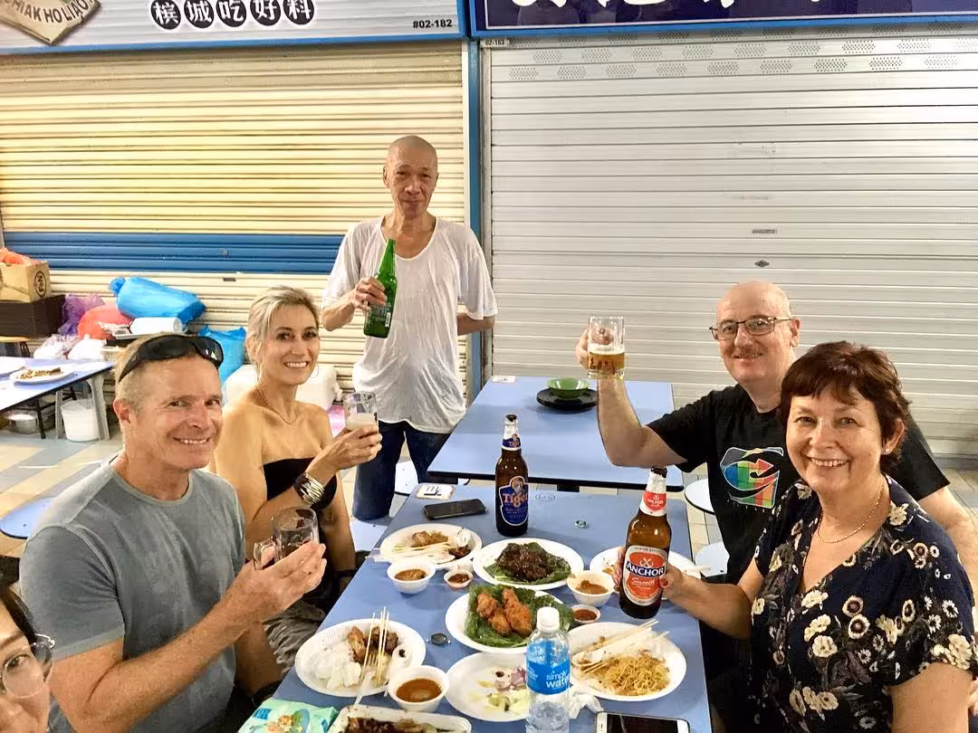Group enjoying local street food and drinks, capturing the vibrant atmosphere of ethnic neighborhoods in a UNESCO tour.