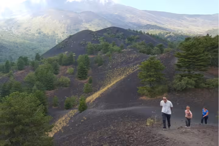 Etna 4x4 Jeep tour from Taormina with travelers exploring volcanic lava field stop on Mount Etna