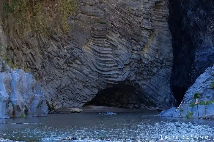 Impressive basalt rock formations at Alcantara Gorge, showcasing natural wonders on the Etna and Alcantara River tour.