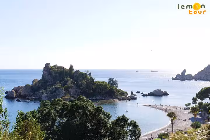 Scenic view of Isola Bella beach with crystal-clear waters and lush greenery on the Etna and Taormina Tour.