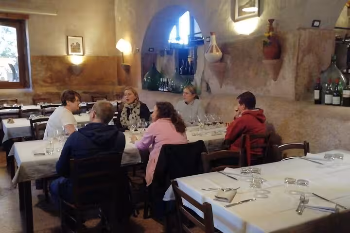 Guests engage in a wine tasting session inside a rustic Sicilian winery near Mount Etna.