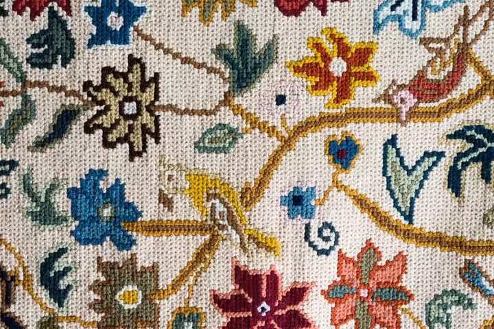 Colorful Arraiolos rug pattern showcasing traditional Portuguese craftsmanship, featured in Évora walking tour product listing.