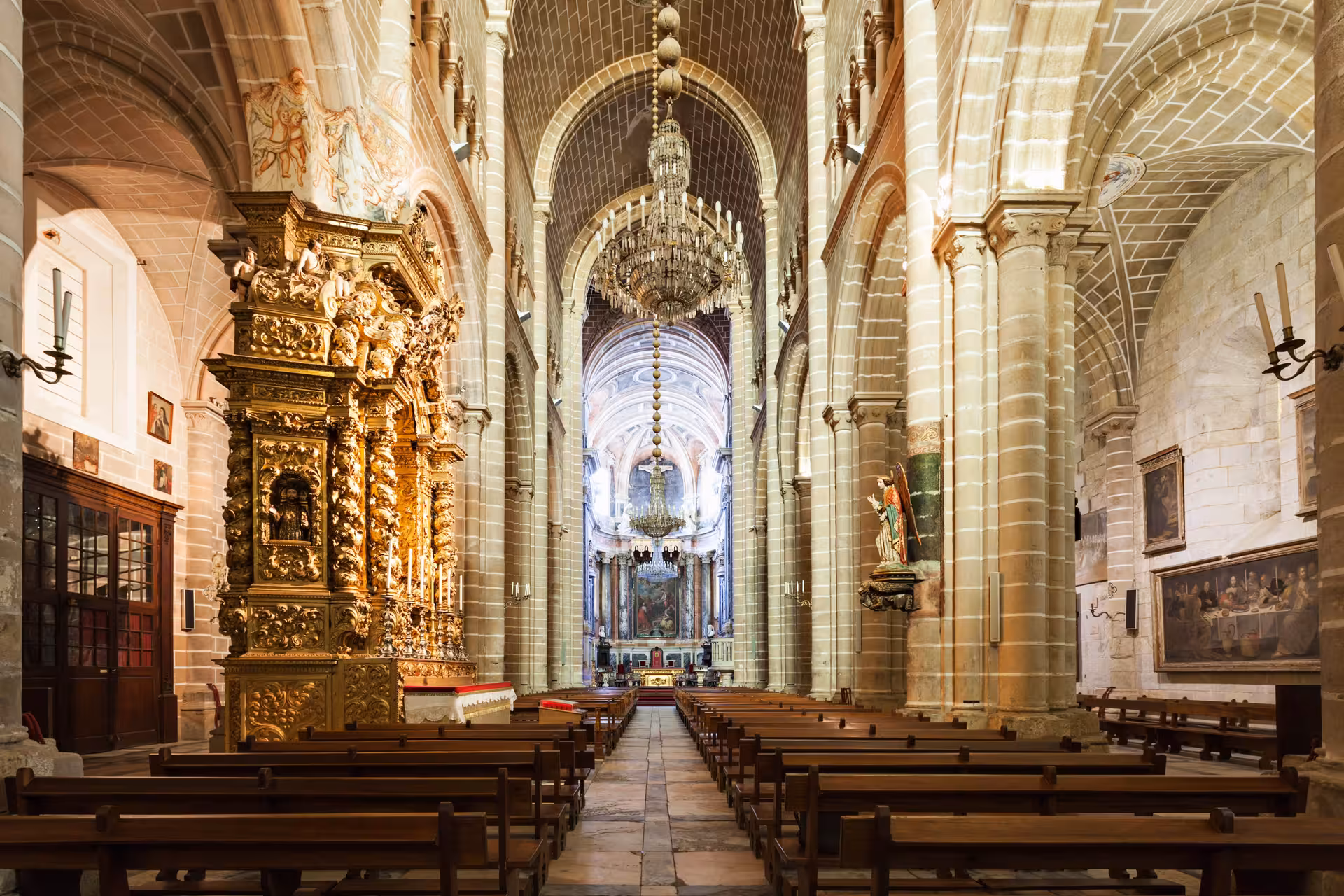 Stunning interior of Évora Cathedral with intricate gold carvings and high arches, a must-see on the private Lisbon tour.