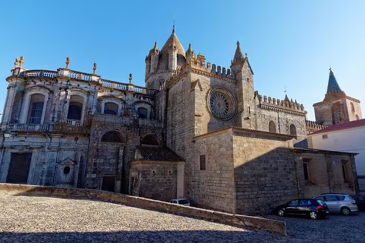Évora Cathedral exterior under blue sky, a highlight on a private customizable day trip from Lisbon