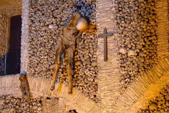 Historic Chapel of Bones in Évora features intricately arranged human skulls and bones, a highlight of the Evora private tour.