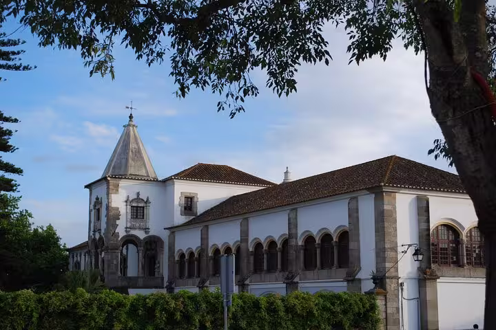 Historic architecture in Évora, Portugal, showcasing classic arches and a spire, featured on the Évora and Monsaraz tour.