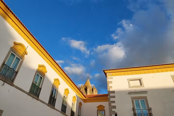 View of Évora's historic architecture with traditional buildings under a clear blue sky, ideal for Jewish history tours.