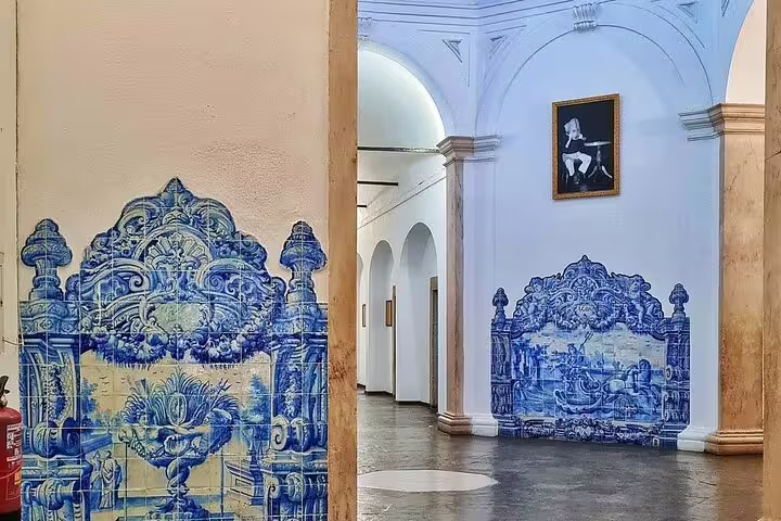 Elegant Portuguese azulejos adorn the walls of a historic building in Évora, showcasing cultural heritage on a full-day Lisbon tour.
