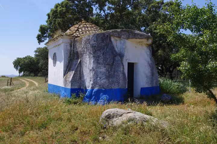 Discover rustic charm with Évora's unique round stone chapel on a private guided tour of prehistoric sites.