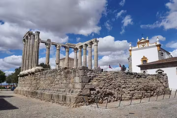 Ancient Roman Temple of Évora under a vibrant blue sky, featured on the Évora & Monsaraz Small-Group Full-Day Tour.