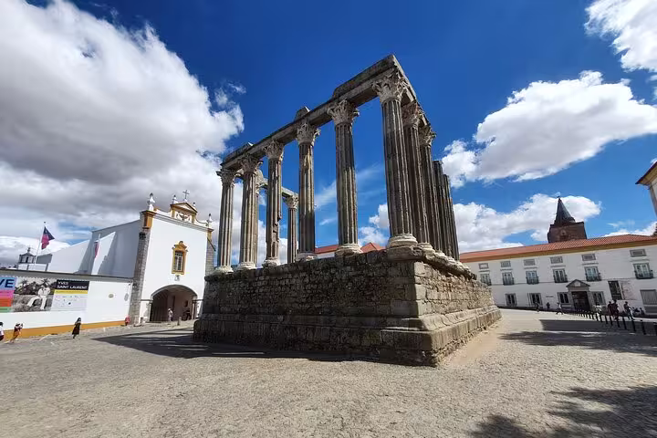 Ancient Roman Temple of Évora under a bright blue sky, capturing the historic charm of the Évora and Monsaraz tour.