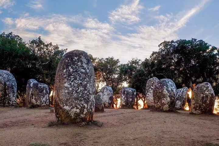 Ancient stone circle under a scenic sky in Évora, Portugal, featured on the Évora Essentials Full-Day Tour from Lisbon.