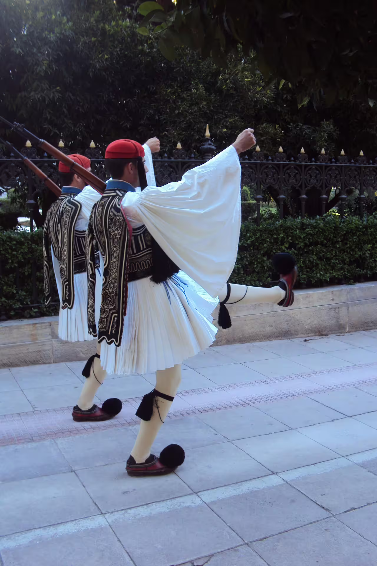 Evzones guards in traditional uniform marching in Athens, cultural highlight on Acropolis, Plaka and Monastiraki tour