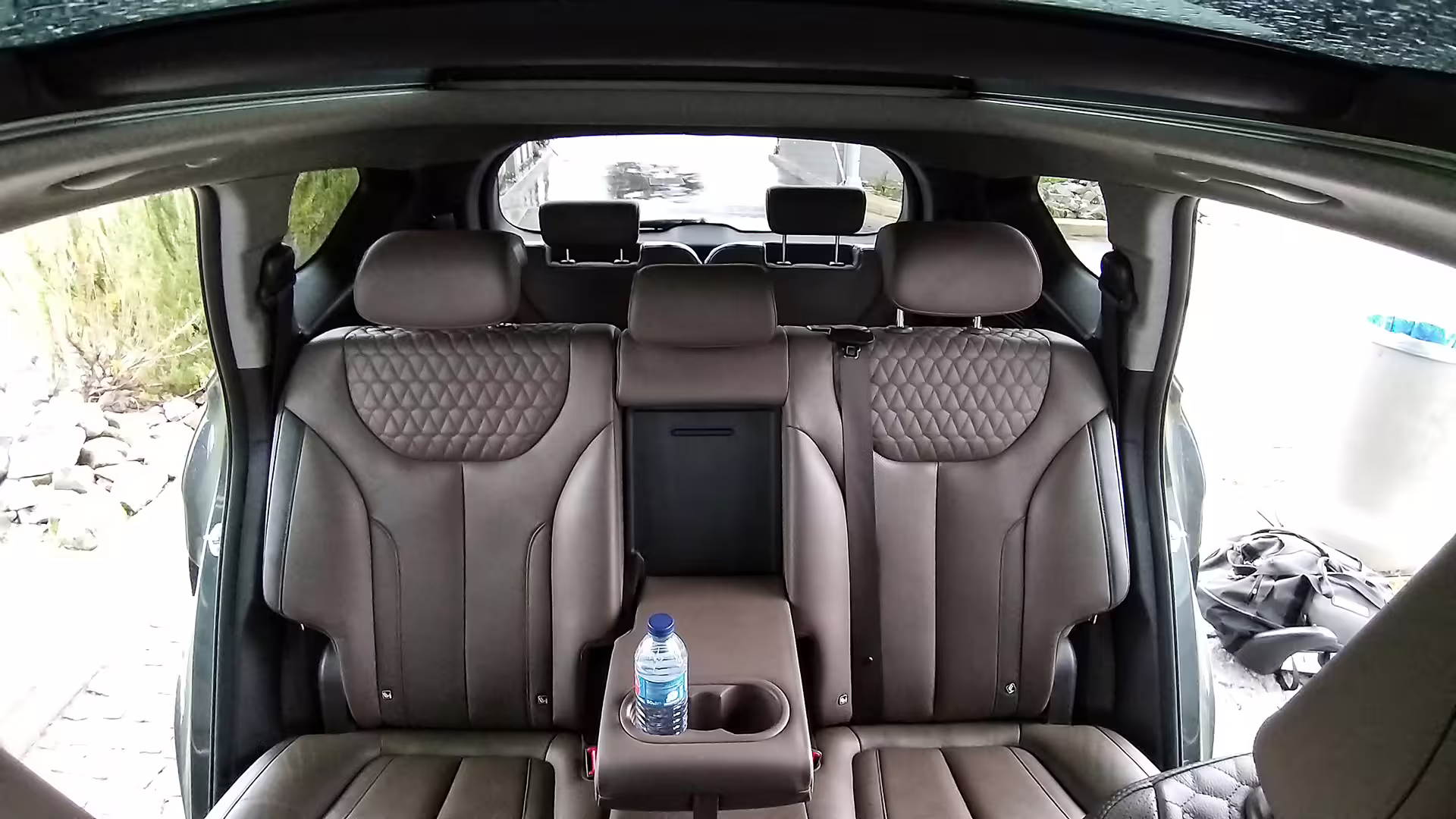Luxurious leather interior of an executive car with water bottle, showcasing comfort for an 8-hour private chauffeur service.
