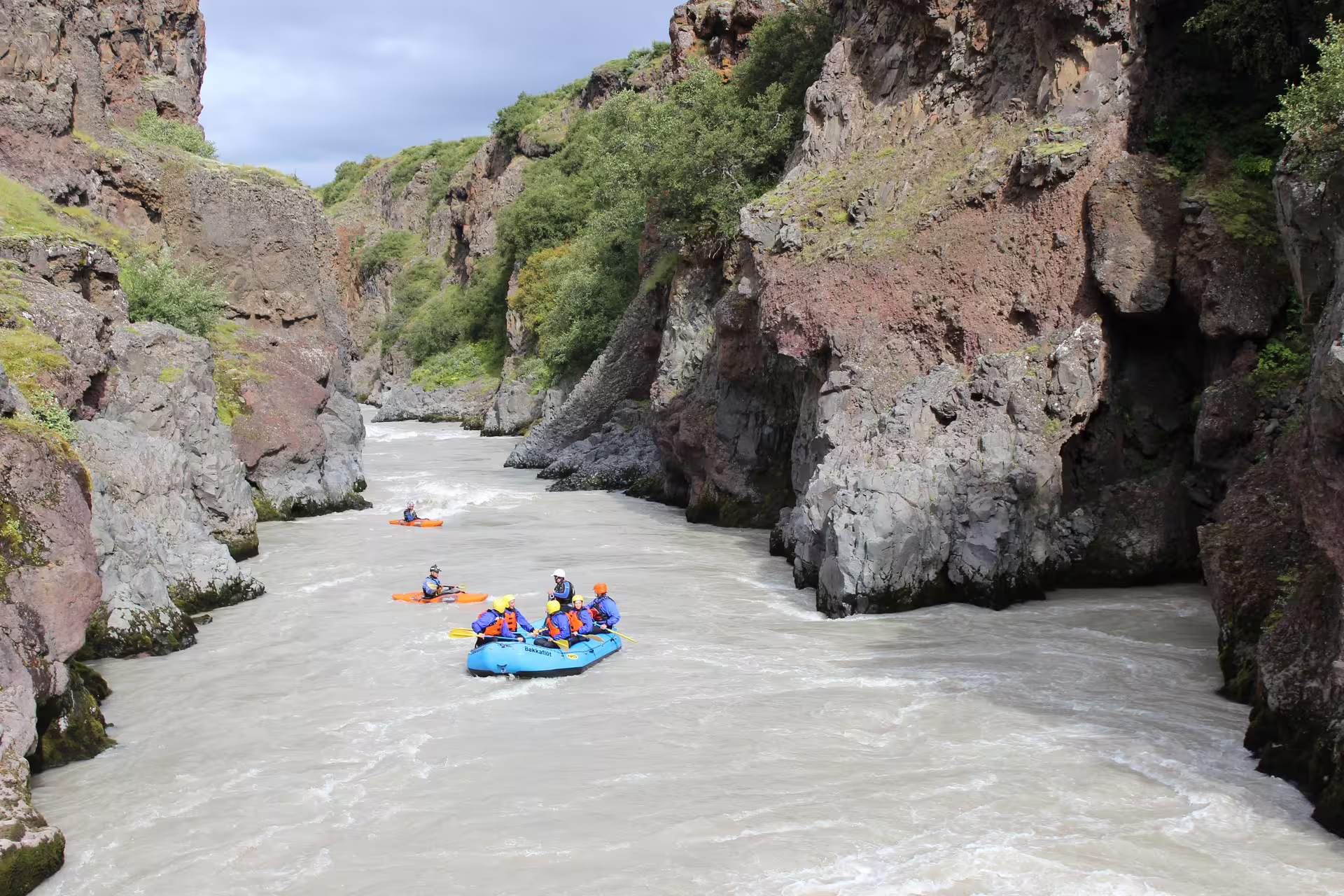 Adventurers navigate rugged canyons and whitewater rapids on an extreme river rafting tour, showcasing thrilling outdoor adventure.