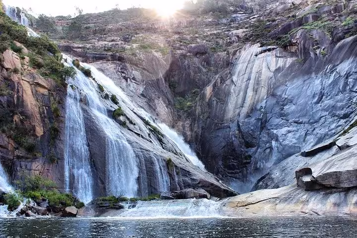 Majestic Ezaro Waterfall cascading down rocky cliffs, a highlight of the Costa da Morte tour in Galicia.