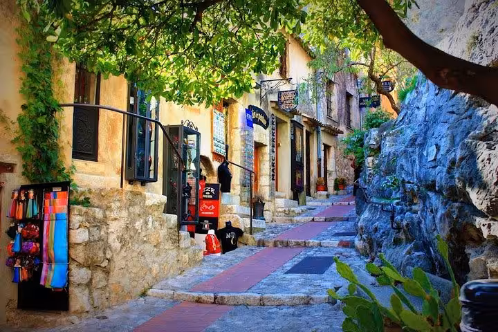 Charming cobblestone street in Eze Village lined with quaint shops, capturing the rustic beauty of the French Riviera.
