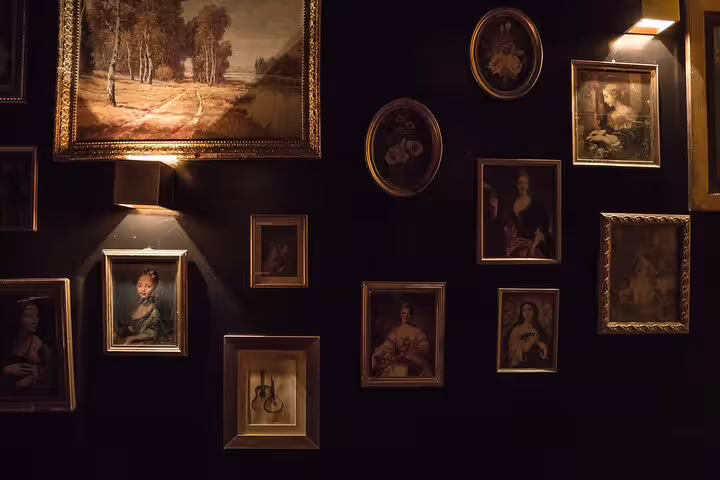 Elegant gallery wall with classic art, enhancing the ambiance of a Fado music dinner in Lisbon.