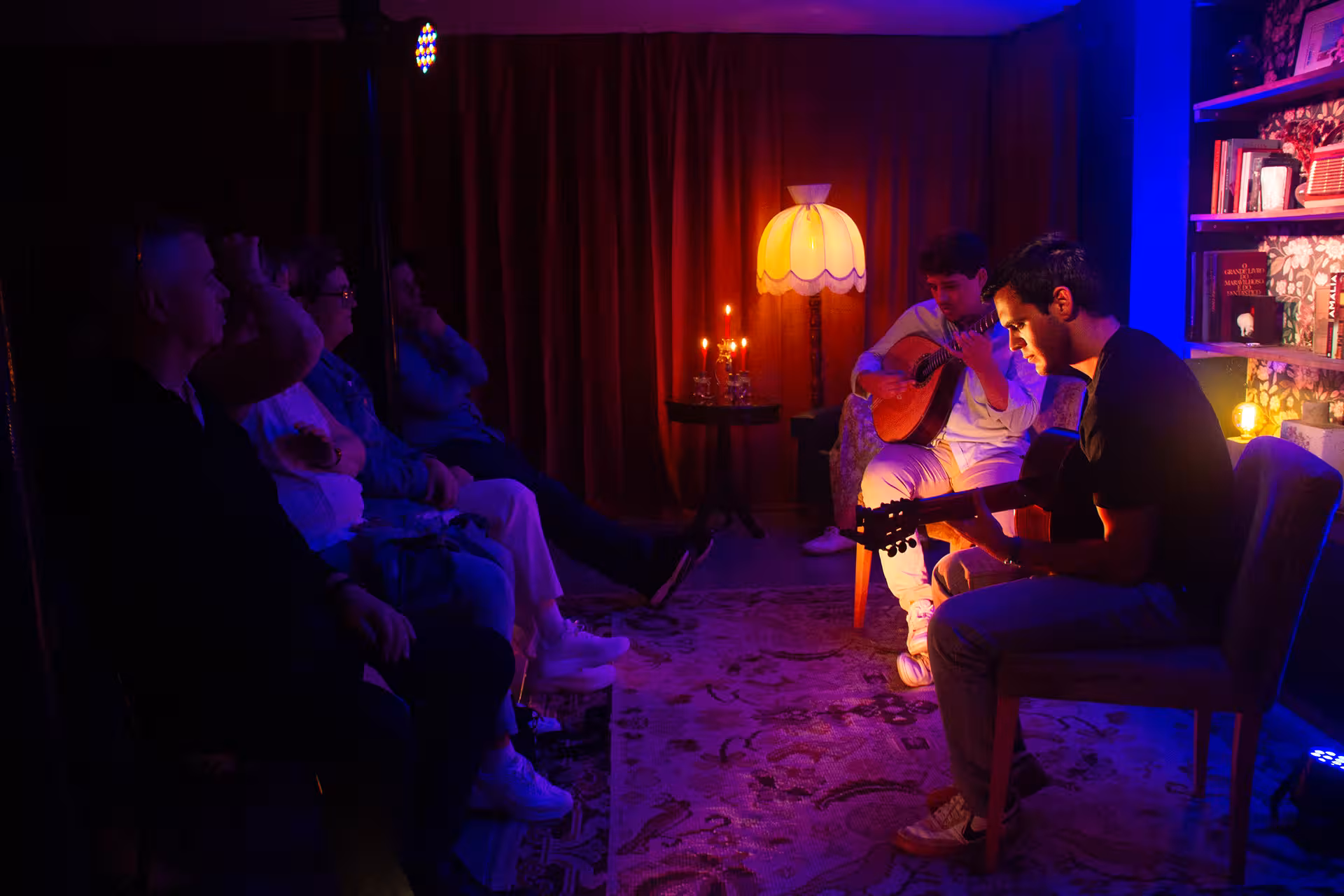 Audience captivated by traditional Fado music performance in atmospheric Lisbon venue.