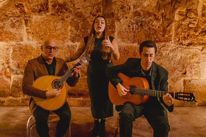 Musicians perform traditional Fado music with guitars and singer in an intimate Lisbon setting, highlighting cultural heritage.