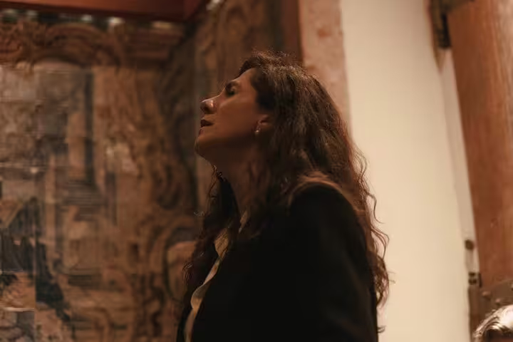 Fado singer passionately performing at Mesa de Frades, offering an authentic Portuguese musical experience in Lisbon.