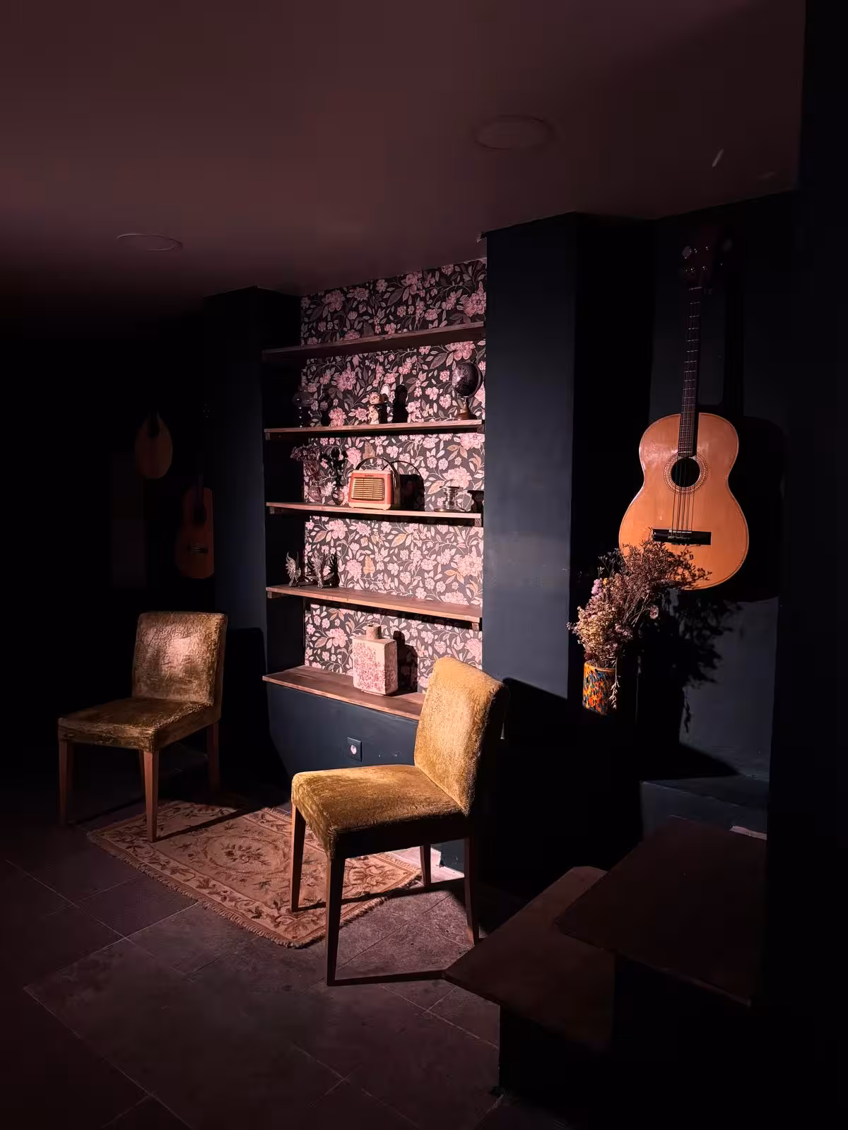 Cozy Fado venue in Lisbon with vintage decor and Portuguese guitars on display.